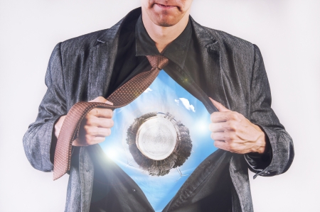 an image of young businessman pulls shirt and shows earth planetの写真素材