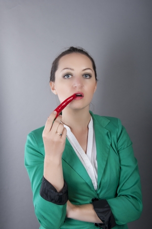 an image of businesswoman holding red chilli pepperの写真素材