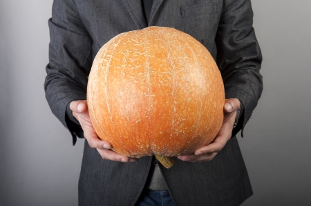an image of vegetarian vegetable businessman holds in handsの写真素材