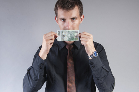 an image of businessman is eating a sandwich with money