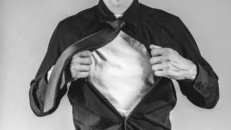 an image of young businessman pulls shirtの写真素材