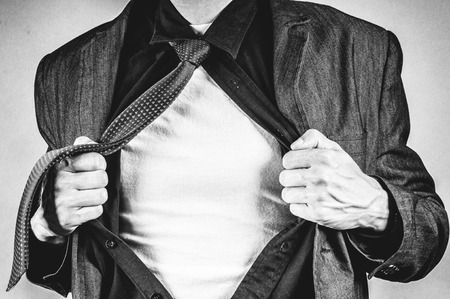 an image of young businessman pulls shirtの写真素材