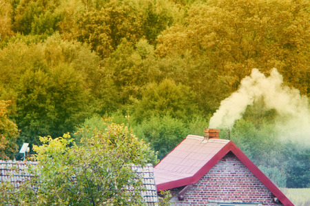 An image of moke coming out of chimneyの写真素材
