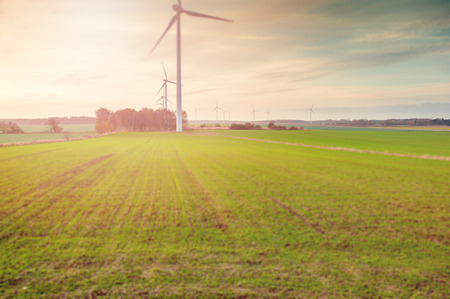 Wind turbine farm with rays of light at sunset
