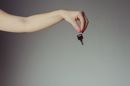 Keys from the car hold by female handの写真素材