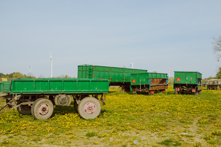 Green agricultural trailers on the farm in the morning.の写真素材