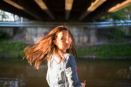 Woman on sidewalk in the city parkの写真素材