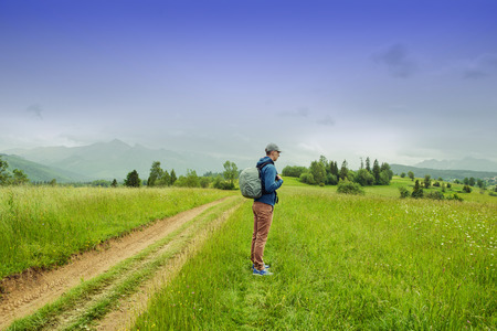 Traveler Man with backpack mountaineering Travel Lifestyle concept rocky mountains on background adventure vacations outdoorの写真素材