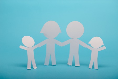 abstract paper people holding for hands on blue backgroundの写真素材