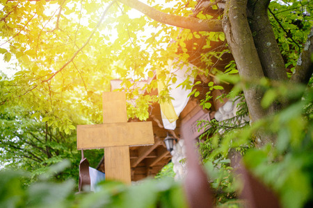 Wooden cross in the forest in summer dayの写真素材