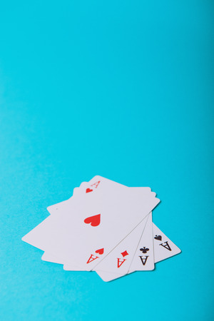 The combination of playing cards poker casino. Isolated on blue background.の写真素材
