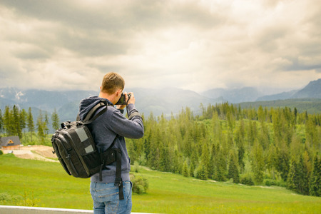 Nature photographer taking photos in the mountains.の写真素材