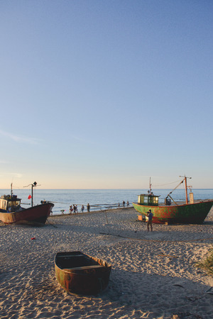 fisherman boats at sunrise time on the beach in summerの写真素材