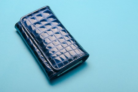Blue ladies leather purse on a blue backgroundの写真素材