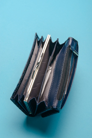 Blue ladies leather purse on a blue background