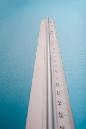 aluminum ruler on blue background. High resolutionの写真素材