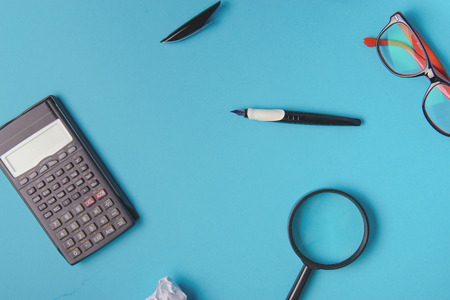 Desk with Tools and Notebook office desk on blue backgroundの写真素材