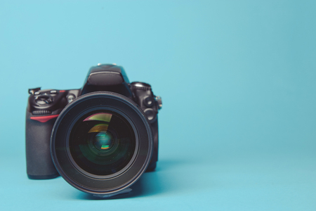 Professional modern DSLR camera against blue backgroundの写真素材