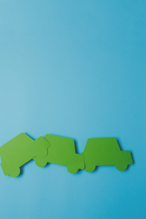 paper green cars figure. top view on blue backgroundの写真素材