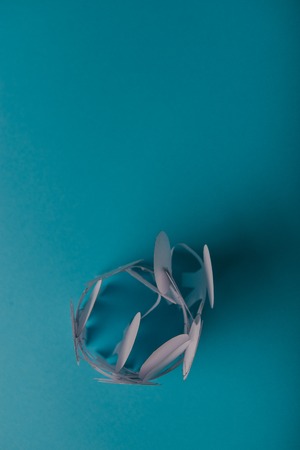 abstract paper people holding for hands on blue backgroundの写真素材