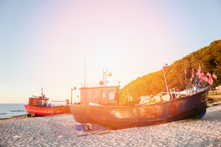 fisherman boats at sunrise time on the beach in summerの写真素材