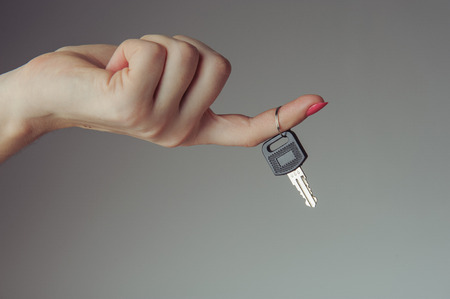 Keys from the car hold by female handの写真素材