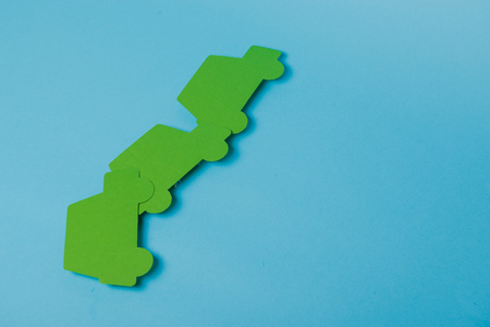paper green cars figure. top view on blue backgroundの写真素材