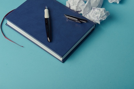 Desk with Tools and Notebook office desk on blue backgroundの写真素材