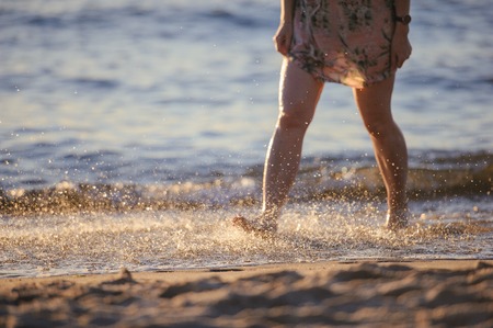 Vacation holidays. Feet closeup on beach on sunbed enjoying sun on sunny summer day.の写真素材