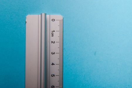 aluminum ruler on blue background. High resolutionの写真素材