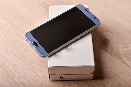 Perfectly detailed modern smart phone on a deskの写真素材