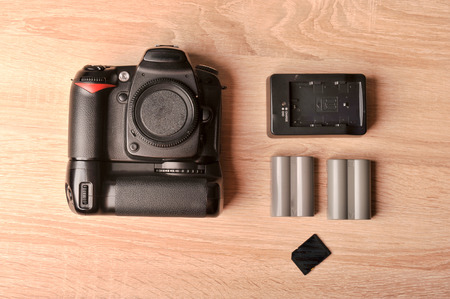 DSLR digital camera on wooden desk tableの写真素材