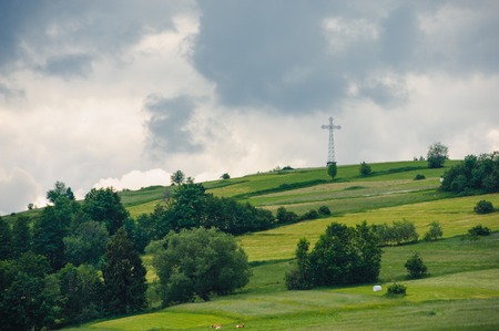 Hills covered with green grass under blue sky Summer landscape backgroundの写真素材