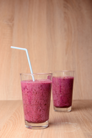 Blueberry smoothie with fresh berries, chia seeds and banana for breakfast on rustic wooden background, selective focusの写真素材