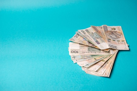 Polish zloty in notes and coins on blue backgroundの写真素材