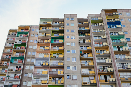 blocks of flats against blue cloudy skyの写真素材
