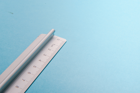 aluminum ruler on blue background. High resolutionの写真素材