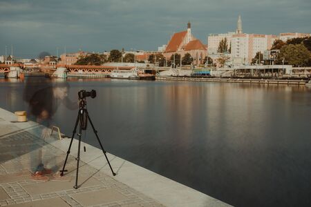Professional urban photographer taking picture in city. Long exposure photography