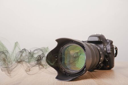 Digital photo camera on wooden desk tableの写真素材