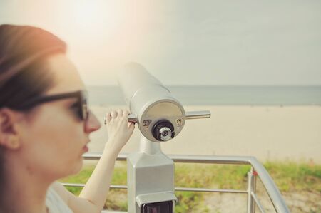 Close-Up of Sightseeing Binoculars with Beach Background