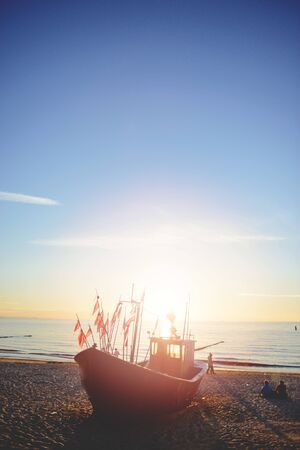 fisherman boats at sunrise time on the beach in summerの写真素材