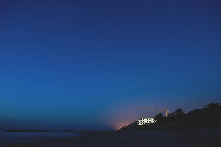Coastal area with a star-filled sky at Baltic Seaの写真素材