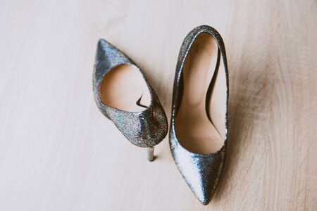 Black high heel women shoes isolated on wooden tableの写真素材