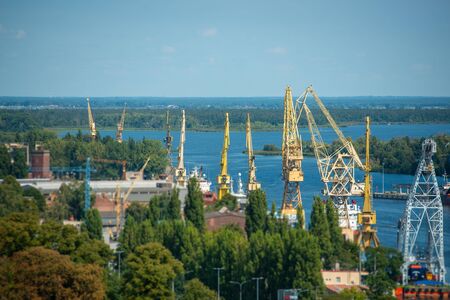 Cityscape with yellow cranes in the background in Szczecin Polandの写真素材