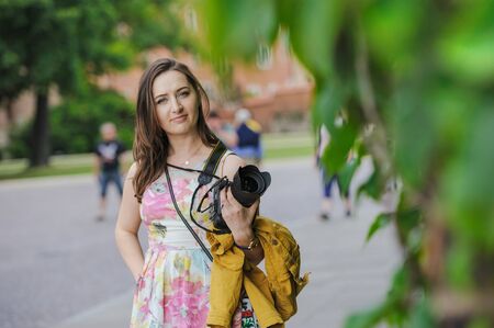 Female tourist takes picture in historic city in Cracow, Poland.の写真素材