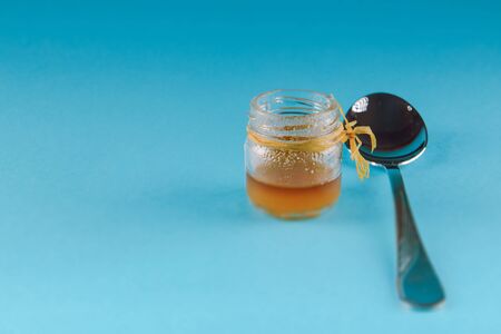 close up of honey jar on blue backgroundの写真素材