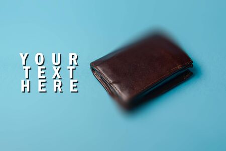 brown mans leather wallet on a blue background. Copy space