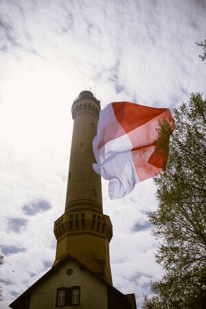 Polish flag hung on at historical lighthouse located in Swinoujscie, Poland, The construction was...