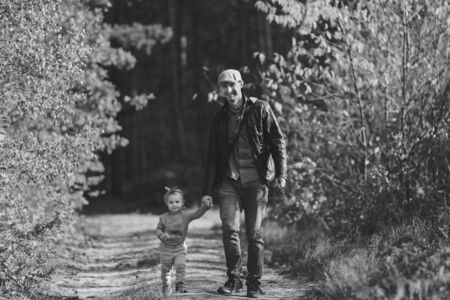 Happy loving family. Father and his daughter child girl playing and hugging outdoors. Cute little girl hugs daddy. Concept of Father's day.の写真素材