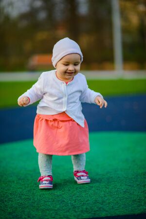 Little girl spending fantastic time on playground. Happy childhood.